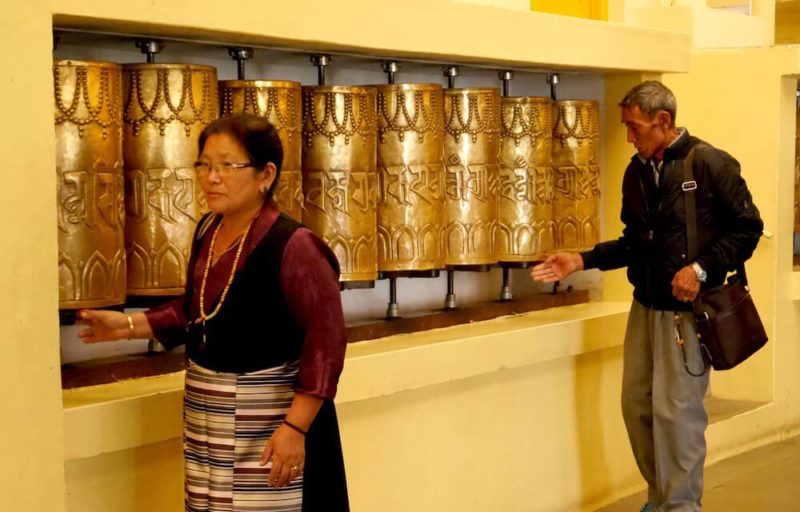 the Tibetans turning prayer wheels in the Dalai Lama temple, McLeod Ganj, Dharamsala, India